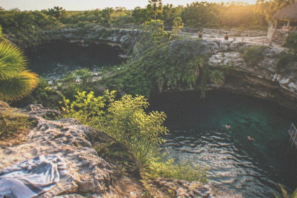 Two sinkhole pools surrounded by jungle greenery near Tulum